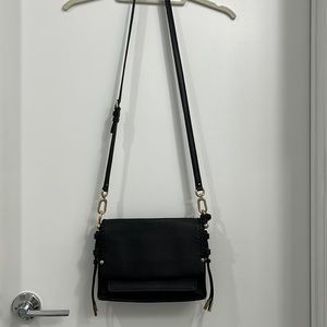 New Stuart Weitzman genuine black leather cross body purse with gold metal